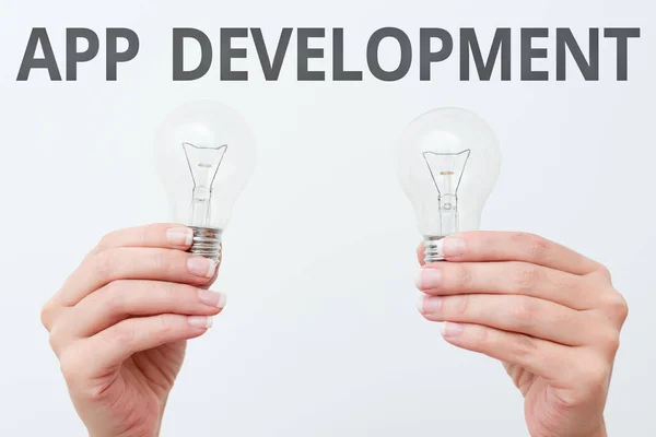Writing displaying text App Development. Word for the act or process by which a mobile app is developed two Hands holding lamp showing or presenting new technology ideas — Stock Photo, Image