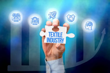 Sign displaying Textile Industry. Word Written on production and distribution of yarn cloth and clothing Hand Holding Jigsaw Puzzle Piece Unlocking New Futuristic Technologies. clipart