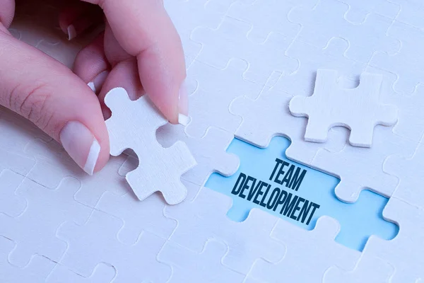 Handschrift tekst Team Development. Word Written on the enhancement of the effectiveness of working groups Building An Unfinished White Jigsaw Pattern Puzzle With Missing Last Piece — Stockfoto