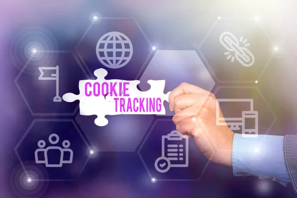 Text sign showing Cookie Tracking. Business concept Data stored in the user s is computer by website being visited Hand Holding Jigsaw Puzzle Piece Unlocking New Futuristic Technologies.