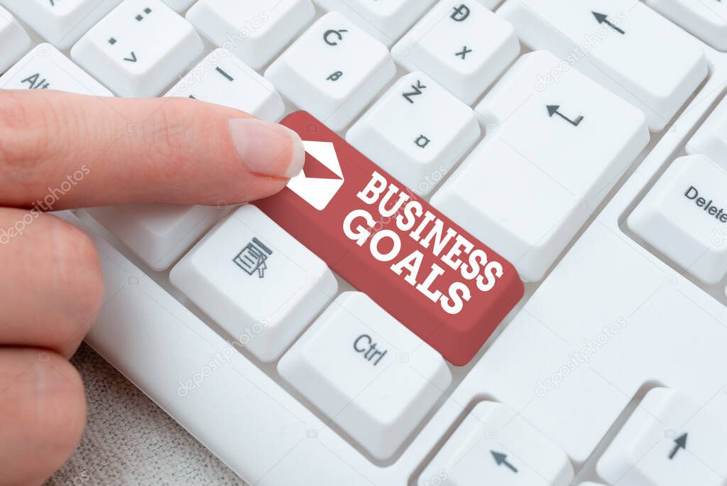 Hand writing sign Business Goals. Business idea company expects to accomplish over a specific period of time Editing New Story Title, Typing Online Presentation Prompter Notes