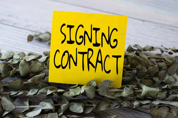 Didascalia concettuale Firma del contratto. Parola per le parti che firmano il documento accettano i termini Blank Piece Of Sticky Note Posizionato sulla cima di un tavolo Accanto a una pianta. — Foto Stock