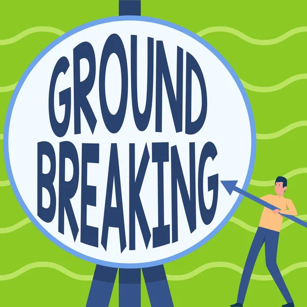 Text sign showing Groundbreaking. Business overview Very new and a big change from other things of its type Man Standing Holding Large Arrow Pointing To Big Circular Target. — Stock Photo, Image