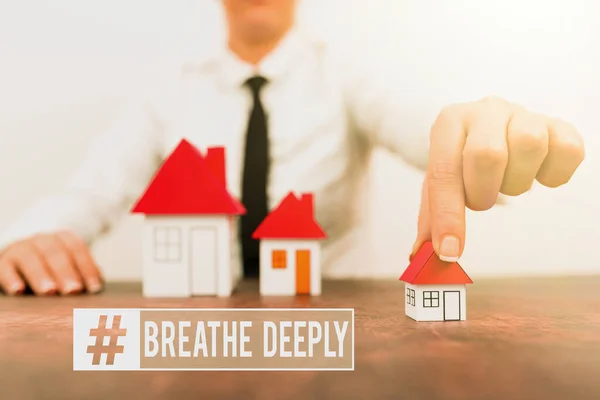 Conceptual caption Breathe Deeply. Business showcase to take a large breath of air into your lungs To pause Different plans for houses represented by business woman