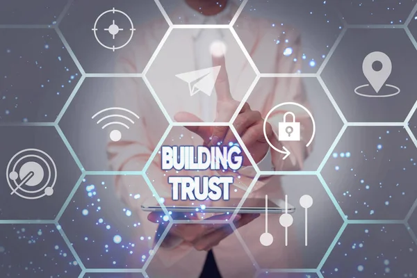 Handwriting text Building Trust. Business approach activity of emerging trust between showing to work effectively Lady In Uniform Holding Tablet In Hand Virtually Tapping Futuristic Tech.