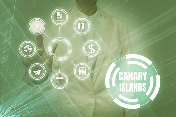 Text caption presenting Canary Islands. Business idea a group of mountainous islands in the Atlantic Ocean Lady In Uniform Holding Tablet In Hand Virtually Tapping Futuristic Tech.