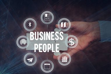 Business People 'ı gösteren bir tabela. İş dünyasında çalışan insanların genel değerlendirmesi. Özellikle de el ele tutuşan yapboz parçasının yeni gelecekçi teknolojilerin kilidini açan yönetici düzeyinde çalışanların..