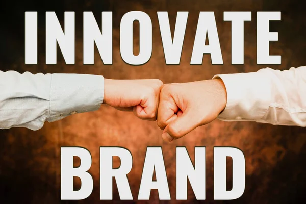 Sign displaying Innovate Brand. Business idea significant to innovate products, services and more Two Professional Well-Dressed Corporate Businessmen Handshake Indoors