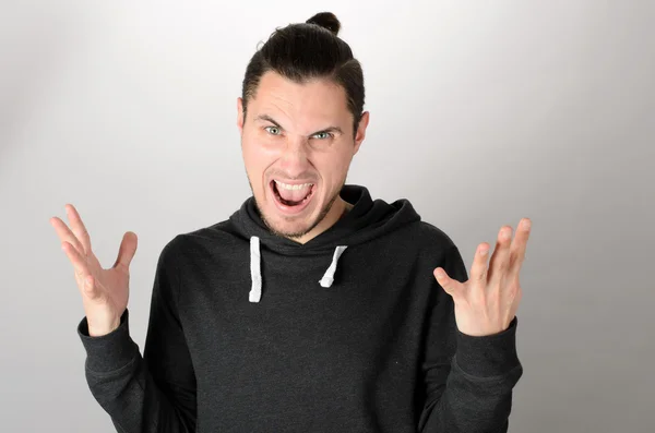 Happy man celebrating his success over gray background — Stock Photo, Image