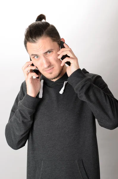 Man talking on two cellphones — Stock Photo, Image