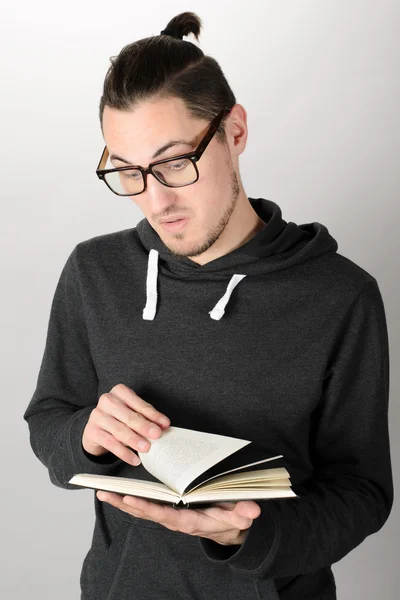 Surprised hipster man reading a book — Stock Photo, Image