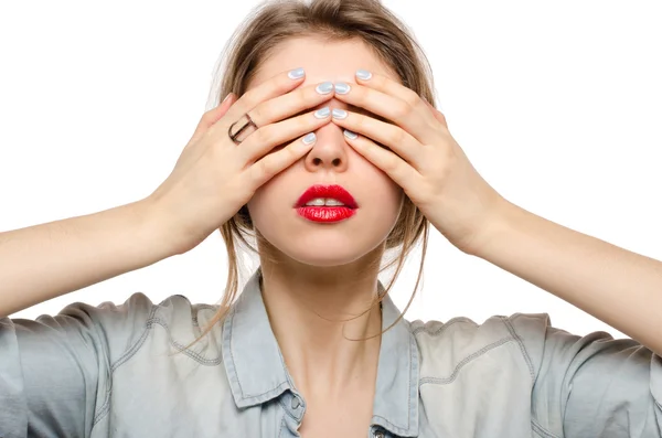 Fashion studio portrait of young beautiful woman with red lips covering her eyes with hands — Stock Photo, Image