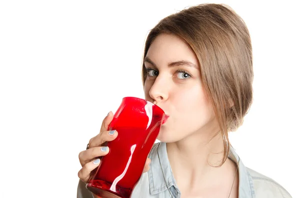 Young beautiful woman enjoying a healthy raw fruit juice. Studio shot. — Stock Photo, Image