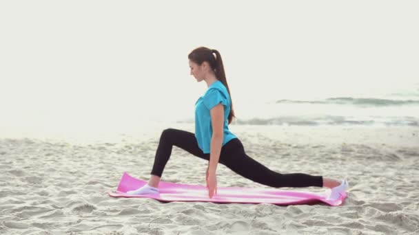 Fiatal nő csinál jóga gyakorlása a nyári homokos strand, napkeltekor — Stock videók