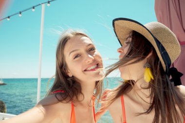 iki genç kadın selfie yapma plajda gülümseyen