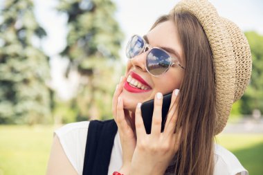 hippi kız trendy bakışla Park smartphone cep telefonu ile konuşmak