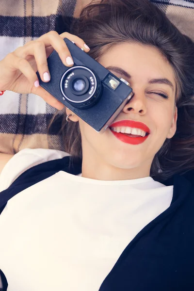 Gelukkig jongedame leggen met oude filmcamera — Stockfoto