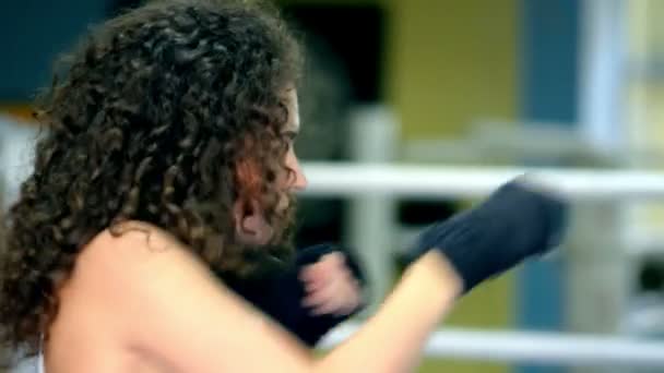 Atletik genç kıvırcık kadın gölge boks, yan görünüm, ağır çekim — Stok video