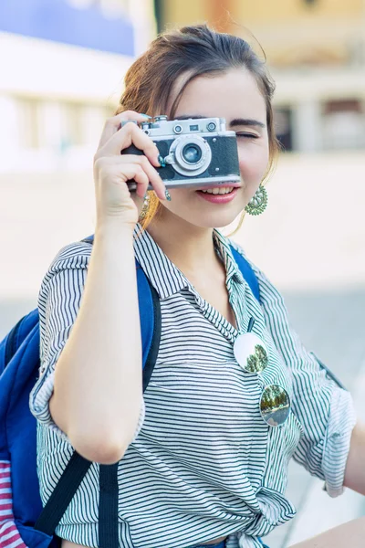 happy young tourist woman or teenage girl with film camera