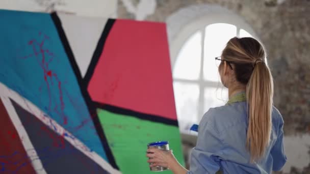 Kadın geniş fırça ve renkli boya kullanır tuval üzerine sıçratma hareketi — Stok video