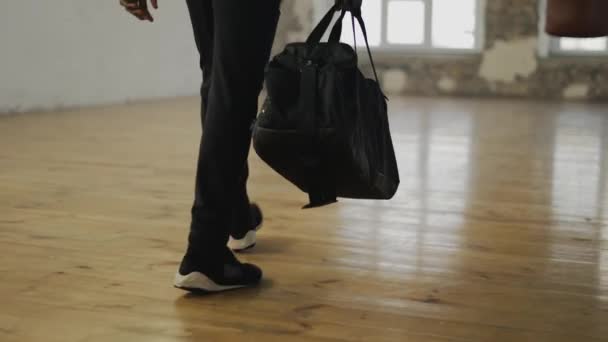 Cropped view of an athlete walking into room with a bag, ready to start training — Stock Video