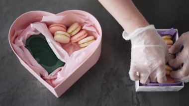 Kadın eli, makarna paketini mutfaktaki hediye kutusuna koyar.