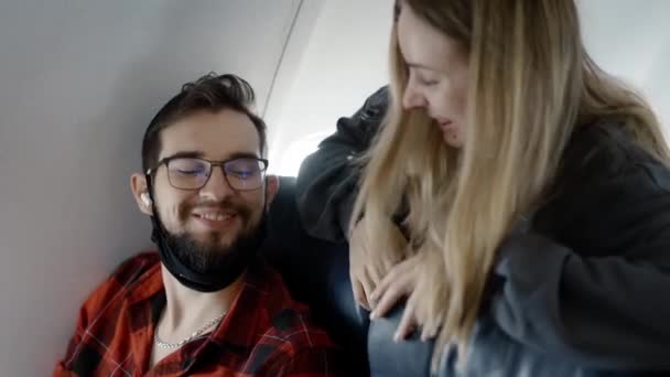 Friends on airplane board travelling together after pandemic time — Stock Video