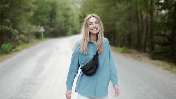 Happy woman walking road in forest, excited, emotional — Stock Video