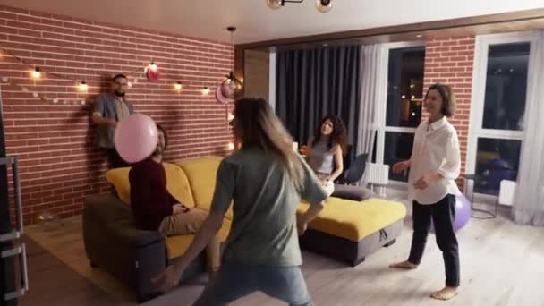 Group of people at living room playing with balloon, have fun together — Stock Video