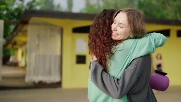 Le donne si sono incontrate e vanno insieme per esercitarsi tenendo stuoie per yoga — Video Stock