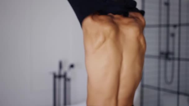 Rückenansicht eines jungen Mannes, der sein Hemd auszieht — Stockvideo