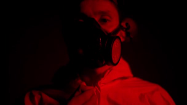 Red smoke shot man in respirator ritsen zijn beschermingspak — Stockvideo