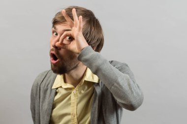 Man looks through a sign ok