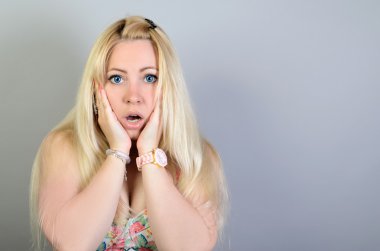 Shocked lady with her mouth opened spread hand, isolated on grey