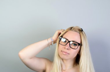beautiful girl thinking on a gray background
