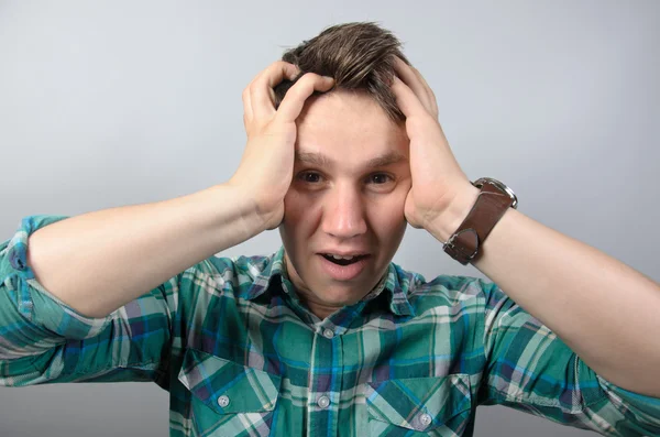 Portrait of frustrasi shock man in shirt standing against grey background — Stok Foto