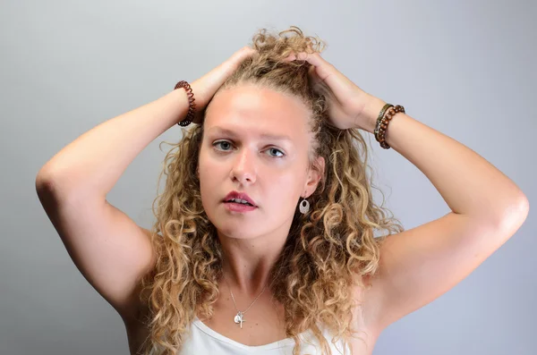 Curly mulher puxando o cabelo — Fotografia de Stock