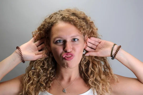 Jeune femme bouclée drôle faisant drôle visage — Photo