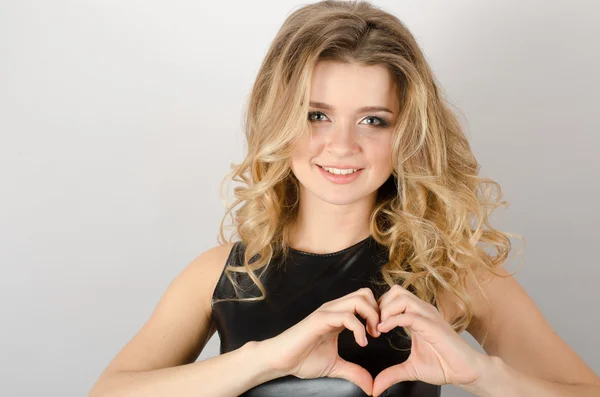 Smiling cheerful happy young woman making heart sign with hands — Stock Photo, Image