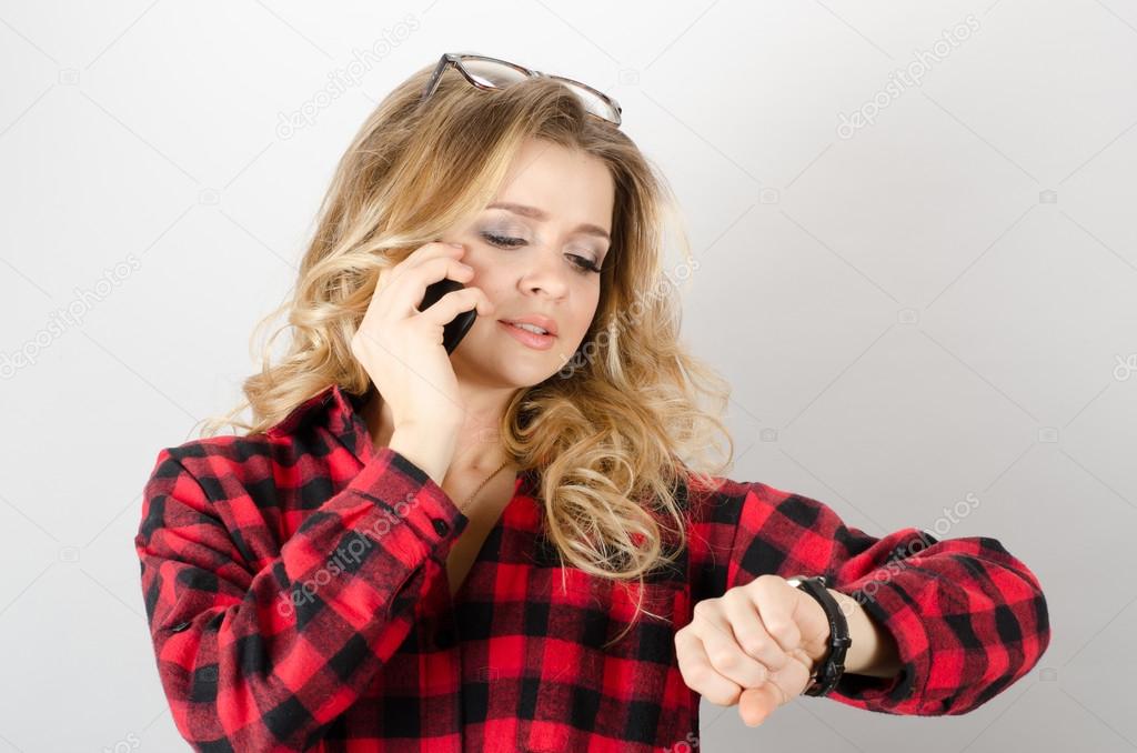 Woman looking at wrist watch, late 