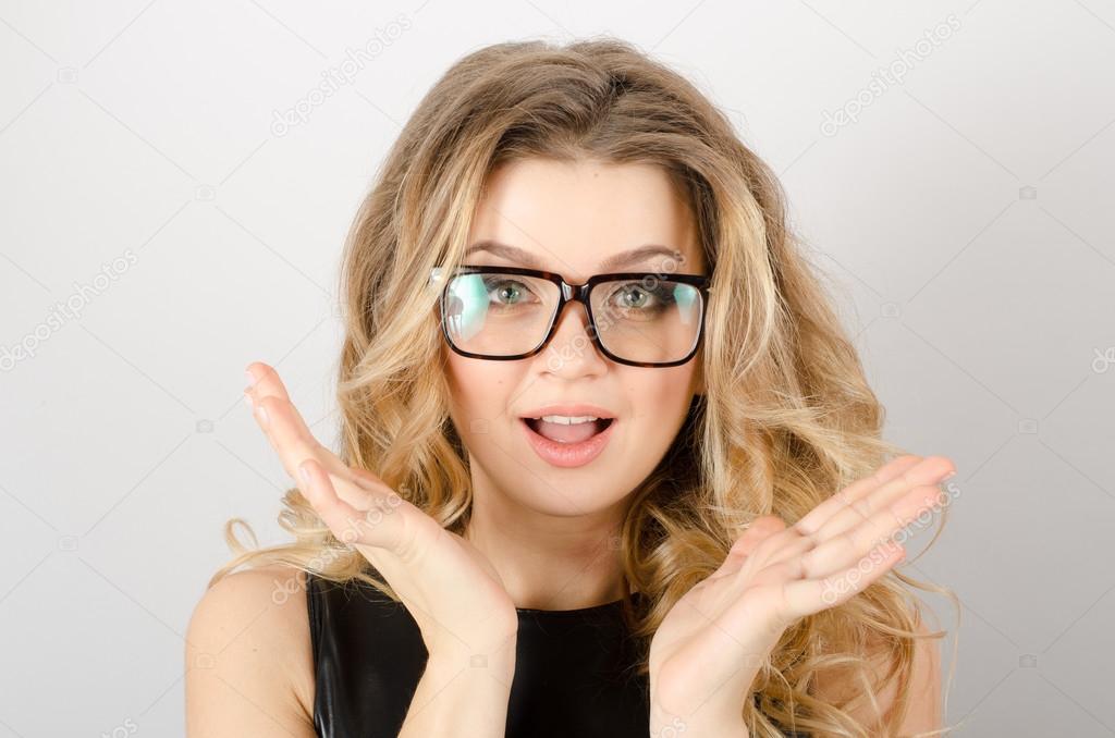 Surprised woman with hands near face