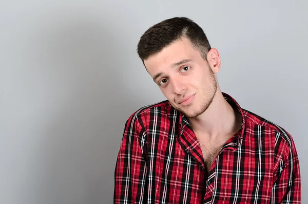 Retrato de jovem sorrindo no fundo cinza — Fotografia de Stock