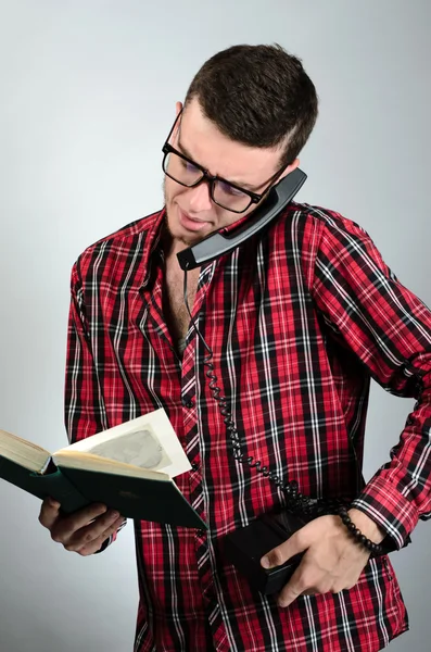 Closeup portrait man talking by phone and holding book — Stock Photo, Image