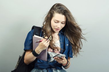 Kitap ve cep tarafından chat yapan genç kadın