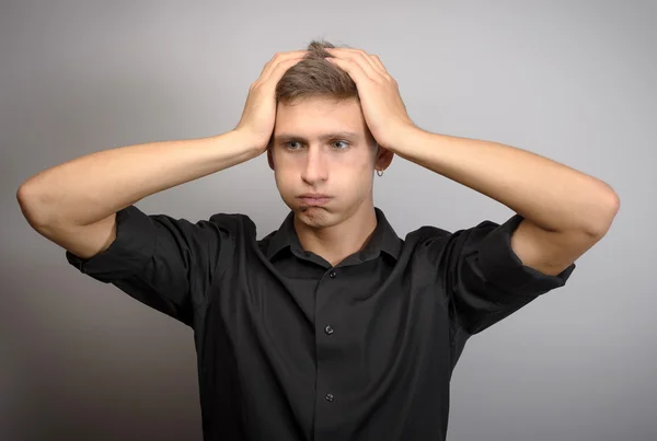 This is too much for me. Confused young man holding head — Stock Photo, Image
