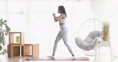 Spor yapan atletik siyah kadın çömelme egzersizleri yapıyor, evde antrenman yapıyor. Sağlıklı bir yaşam tarzı. Fitness.