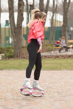 Kangoo zıplama botları içinde kadın fitness eğitmeni. Spor eğitimi konsepti. 