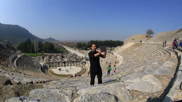 Tourist taking photo in amphitheather — Stock Video