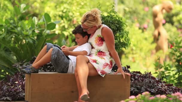 Mother and son using digital tablet — Stock Video