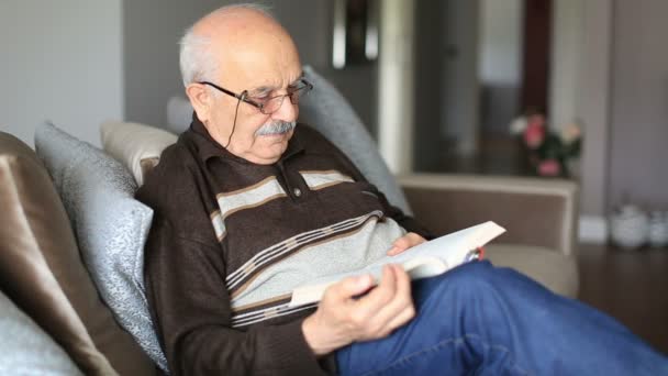 Старший чоловік читає книгу — стокове відео